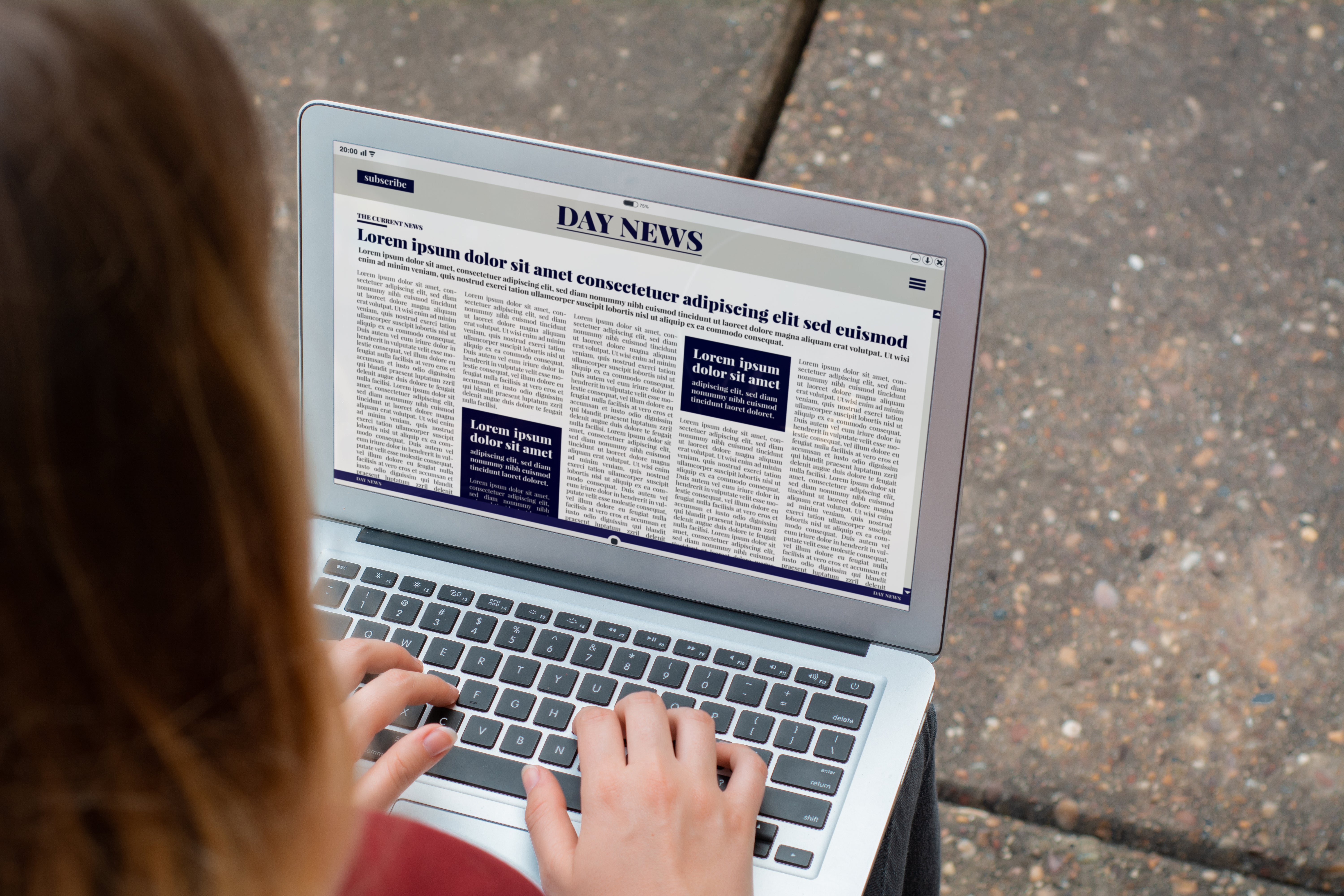 woman typing on laptop and newspaper on laptop 
